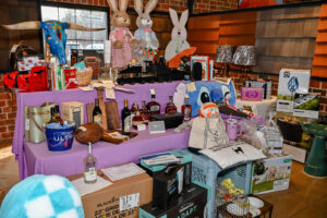 Array of donated items on display for the Live Auction at the 2026 EHFAR Fundraiser, For the Love of Perry Kids