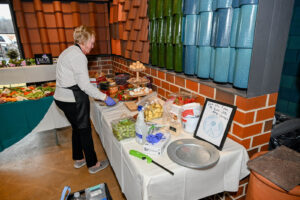 Jody Newlon setting up the dessert buffet courtesy of Trotter's Grill & Bar at the 2026 EHFAR Fundraiser, For the Love of Perry Kids