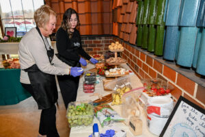 Jody Newlon and Trotter's team member setting up the buffet at the 2026 EHFAR Fundraiser, For the Love of Perry Kids