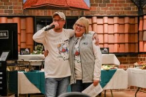 Auctioneer Jeremy Seals with EHFAR Co-Founder Jeanette Addington during the Live Auction at the 2026 EHFAR For the Love of Kids Fundraiser.