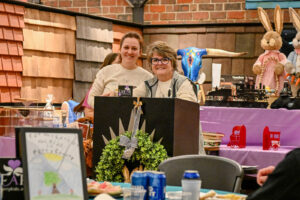 EHFAR Co-Founder Ann Hankinson with her daughter Leah Sowers at the Live Auction podium during the 2026 EHFAR For the Love of Kids Fundraiser.
