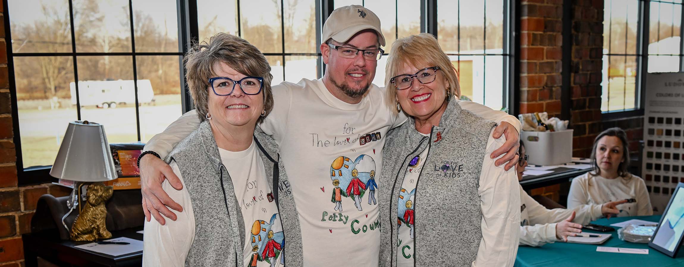 EHFAR co-founders Ann Hankinson and Jeanette Addington with Volunteer Auctioneer Jeremy Seals