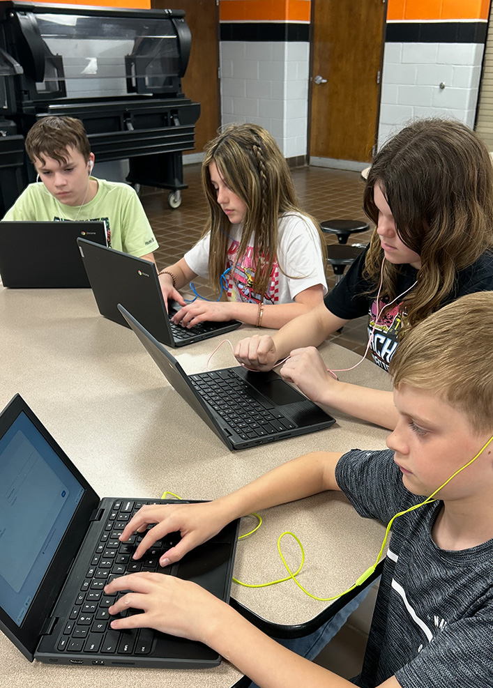 Group of New Lexington, Ohio Middle School students using ear buds donated by EHFAR, the Perry County non-profit benefiting county kids.