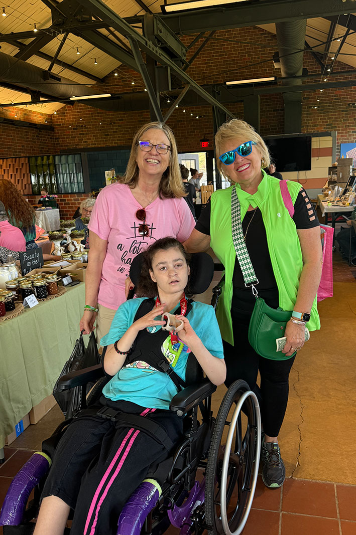 EHFAR Treasurer Jeanette Addington with donation recipient Jody Thompson and her daughter.