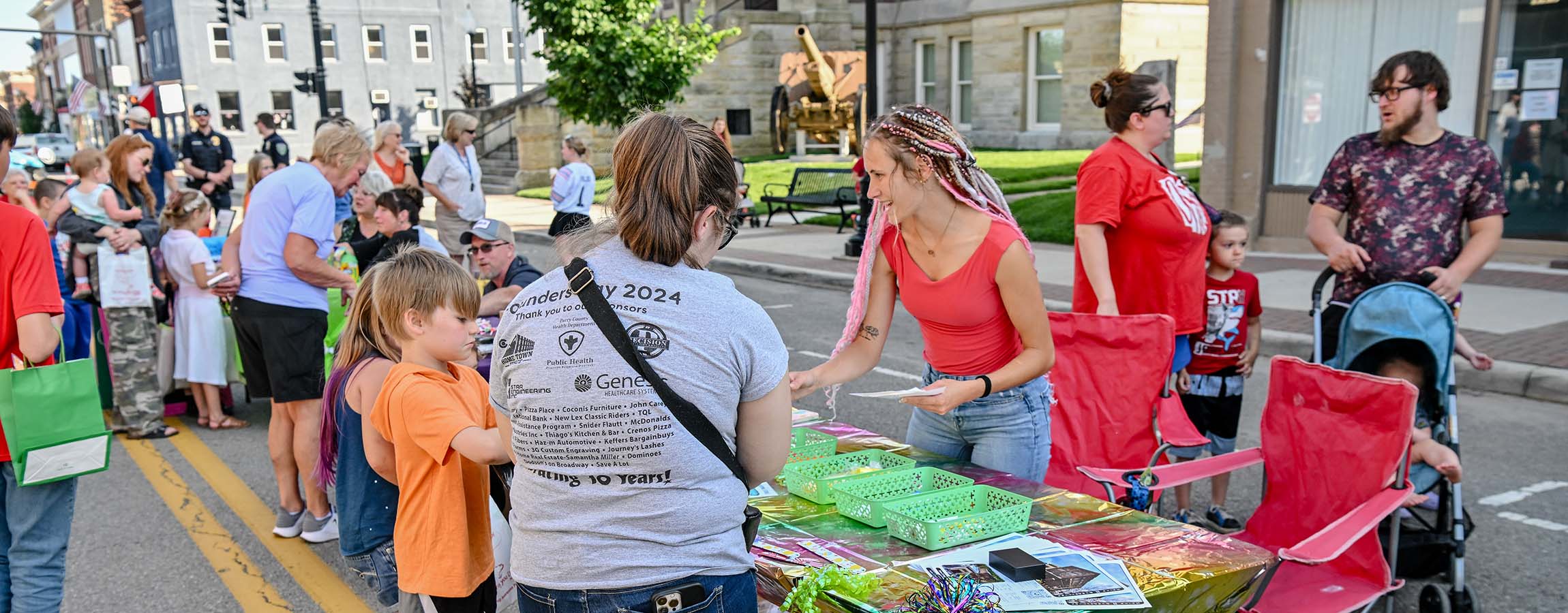 Children enjoying giveaways during the 2026 Chalk It Up to Summer event in New Lexington, Ohio.