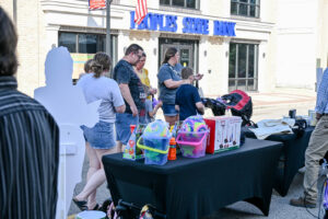 Families enjoying giveaways on Main Street in New Lexington during the 2026 Chalk It Up to Summer event.