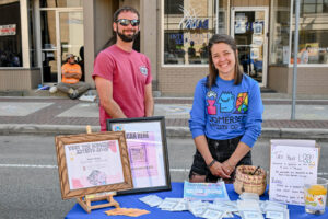 Volunteers from the Somerset Artists' Co-Op on Main Street in New Lexington during the 2026 Chalk It Up to Summer event for kids and families.