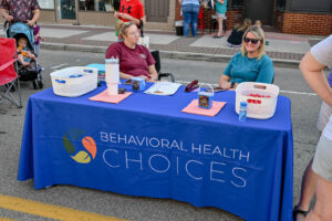 Perry County Behavioral Health Choices volunteers at their table on Main Street in New Lexington during the 2026 Chalk It Up to Summer event for kids and families.