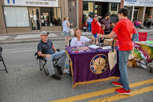 The New Lexington Eagles table on Main Street during the 2026 Chalk It Up to Summer event for kids and families.