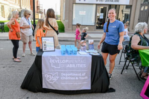 The Perry County Board of DD table with giveaways on Main Street in New Lexington during the 2026 Chalk It Up to Summer event for kids and families.