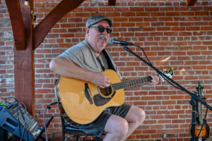 Guitarist Mike Boley playing outdoors at Trotter's in New Lexington during the 2026 Chalk It Up to Summer event for kids and families.