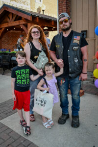 Family standing in front of Trotter's on Main Street in New Lexington during the 2026 Chalk It Up to Summer event for kids and families.