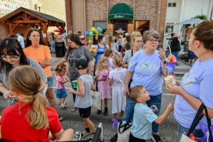 Crown in front of Trotter's on Main Street in New Lexington during the 2026 Chalk It Up to Summer event for kids and families.