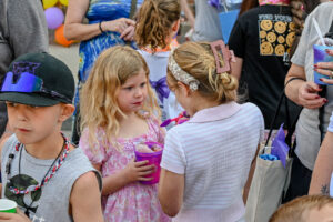 Crowd enjoying KONA Ice on Main Street in New Lexington during the 2026 Chalk It Up to Summer event for kids and families.