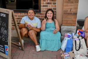 Children enjoying ice cream outside Happy Cones on Main Street in New Lexington during the 2026 Chalk It Up to Summer event for kids and families.